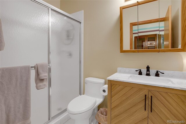 bathroom with vanity, toilet, and an enclosed shower