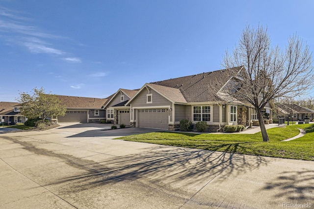 7774 S Biloxi Way, Aurora, CO 80016 - view of front of home featuring a garage, stone siding, a front yard, and concrete driveway