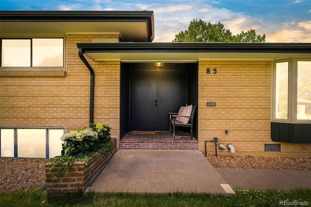 85 S Flower St, Lakewood, CO 80226 - doorway to property with brick siding and crawl space