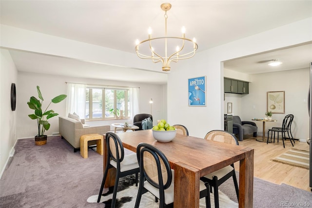 85 S Flower St, Lakewood, CO 80226 - dining space featuring a chandelier, baseboards, and light wood finished floors