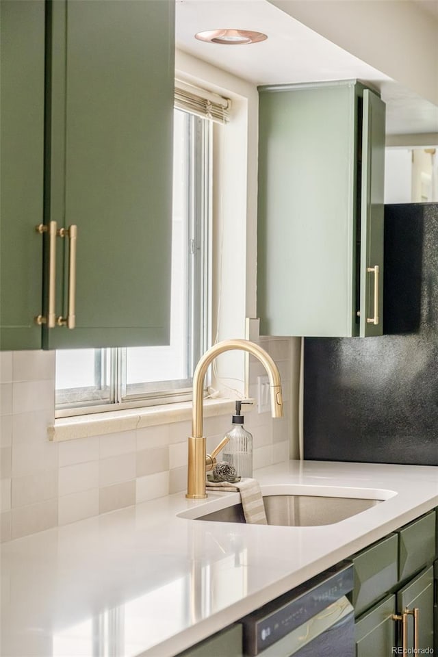 85 S Flower St, Lakewood, CO 80226 - kitchen featuring green cabinets, a sink, dishwashing machine, backsplash, and light countertops