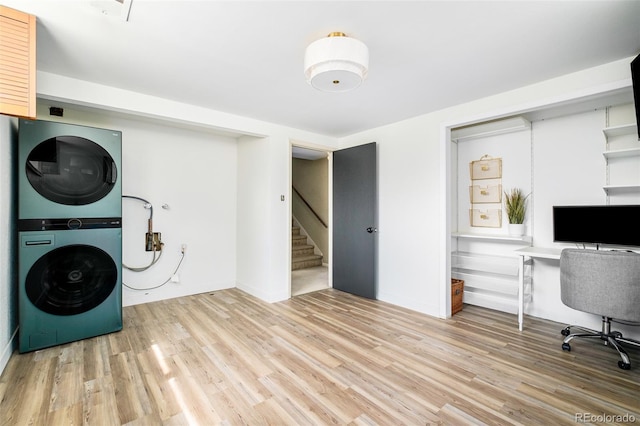 85 S Flower St, Lakewood, CO 80226 - laundry room with stacked washer / drying machine, light wood-style floors, a desk, and baseboards