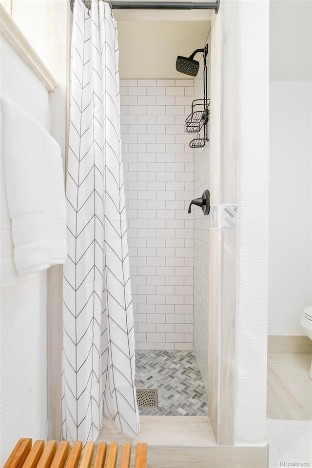 85 S Flower St, Lakewood, CO 80226 - bathroom featuring a stall shower and toilet