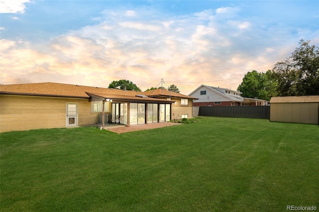 85 S Flower St, Lakewood, CO 80226 - back of property at dusk with a sunroom