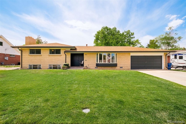 85 S Flower St, Lakewood, CO 80226 - split level home featuring driveway, a garage, a front lawn, and a chimney