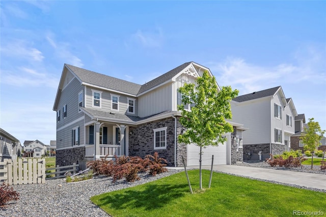 7166 S Vandriver Way, Aurora, CO 80016 - view of front facade featuring stone siding, driveway, covered porch, and board and batten siding