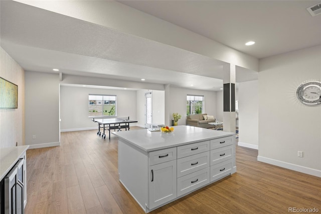 7166 S Vandriver Way, Aurora, CO 80016 - kitchen with light countertops, light wood-type flooring, open floor plan, and recessed lighting