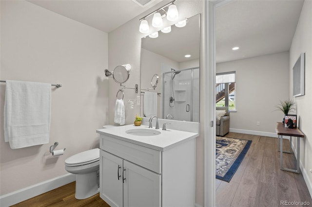 7166 S Vandriver Way, Aurora, CO 80016 - bathroom featuring vanity, a stall shower, and wood finished floors