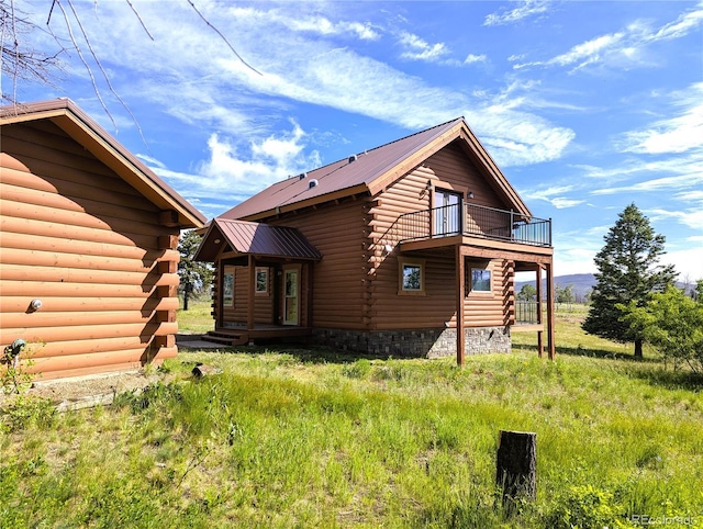 1857 Sturm Ln, Fort Garland, CO 81133 - back of house featuring a balcony, log siding, and a metal roof