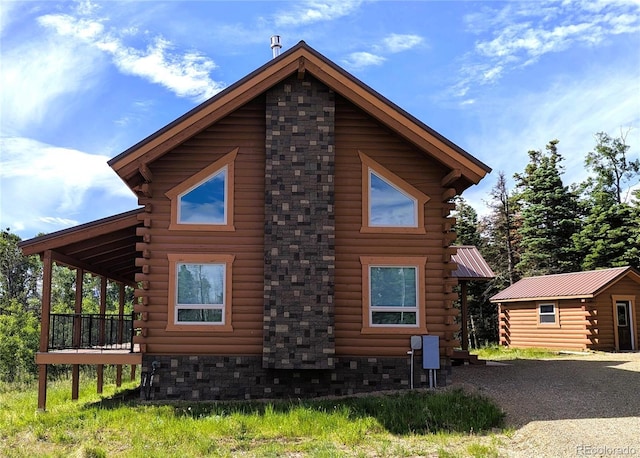 1857 Sturm Ln, Fort Garland, CO 81133 - view of home's exterior featuring log siding, an outbuilding, and a deck