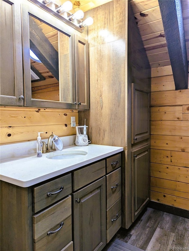 1857 Sturm Ln, Fort Garland, CO 81133 - bathroom featuring vanity, wood finished floors, wooden walls, lofted ceiling, and wooden ceiling
