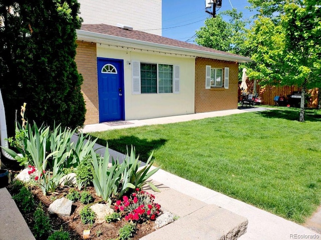 entrance to property with a lawn