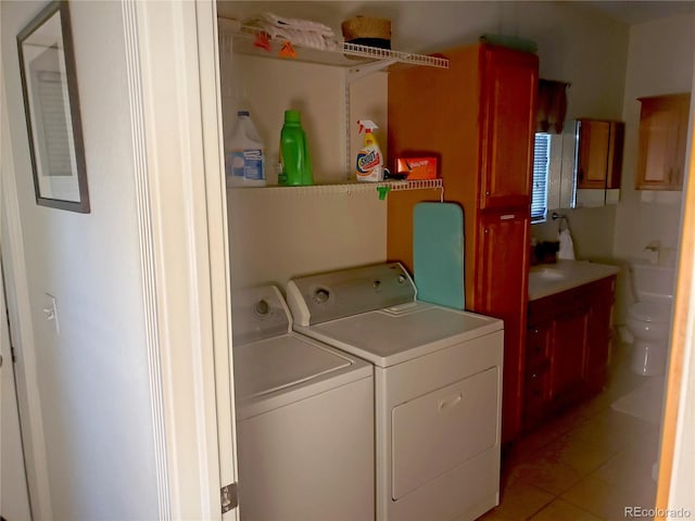 laundry area featuring light tile patterned flooring and washing machine and clothes dryer