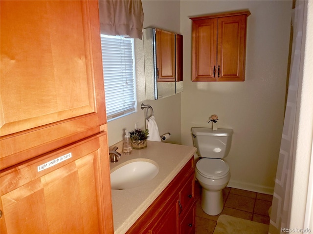 bathroom with vanity, tile patterned flooring, and toilet