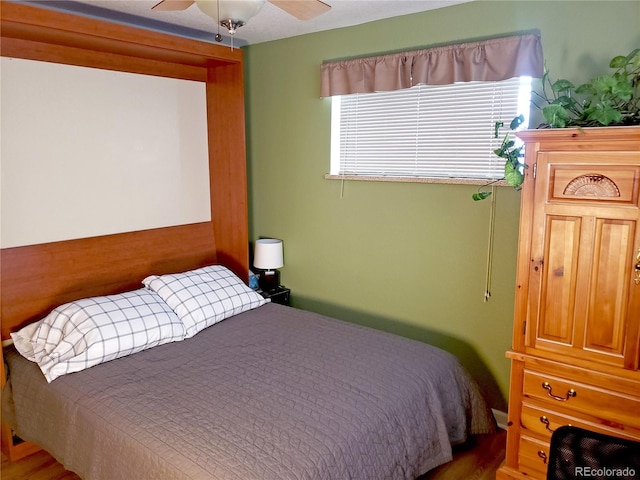 bedroom featuring wood-type flooring and ceiling fan