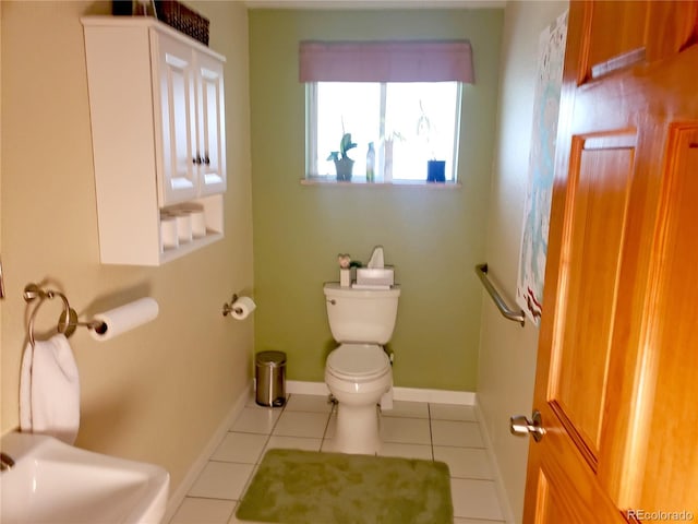 bathroom with tile patterned flooring and toilet