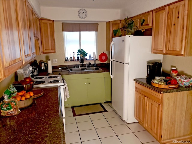 kitchen featuring light tile patterned floors, sink, and white fridge