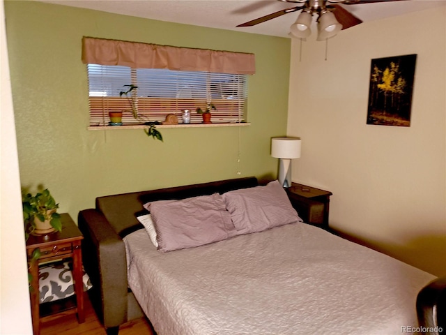 bedroom featuring hardwood / wood-style flooring and ceiling fan