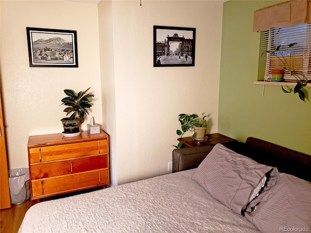 bedroom with hardwood / wood-style flooring