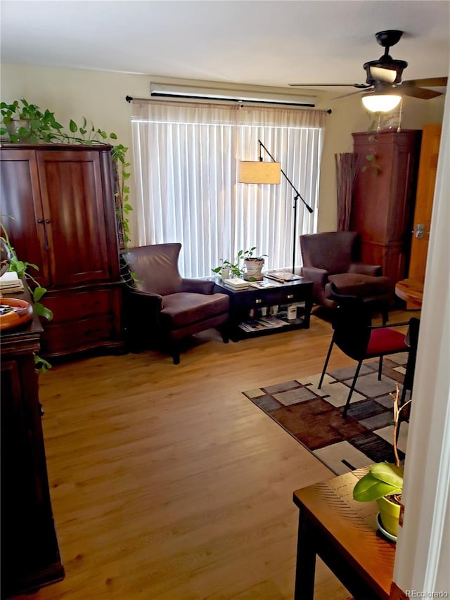 sitting room featuring light hardwood / wood-style flooring and ceiling fan