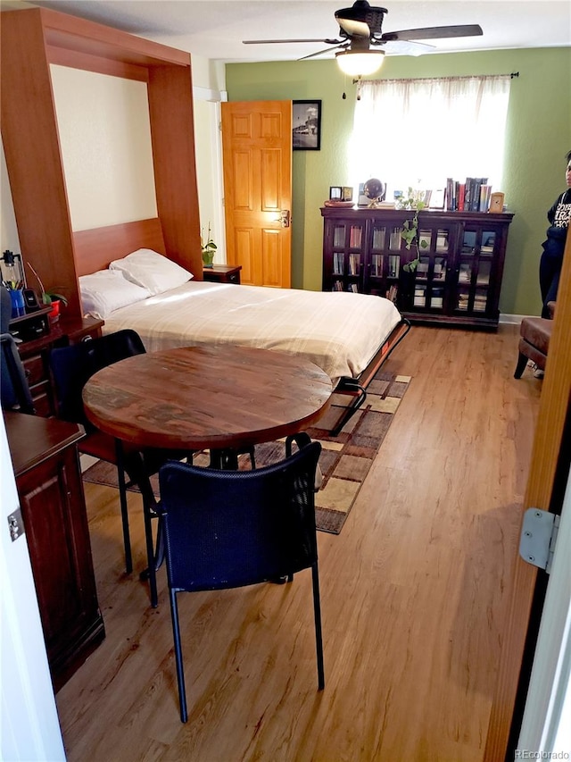 bedroom with light wood-type flooring and ceiling fan