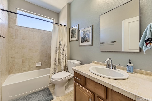 full bathroom featuring tile patterned floors, vanity, toilet, and shower / bath combo with shower curtain