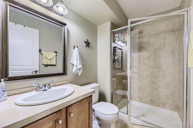 bathroom featuring walk in shower, vanity, and toilet