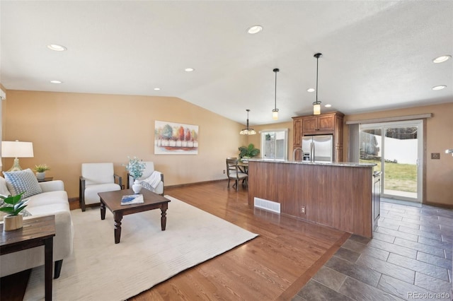 living area with lofted ceiling, recessed lighting, visible vents, and baseboards