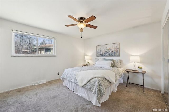 bedroom featuring visible vents, baseboards, ceiling fan, and carpet flooring