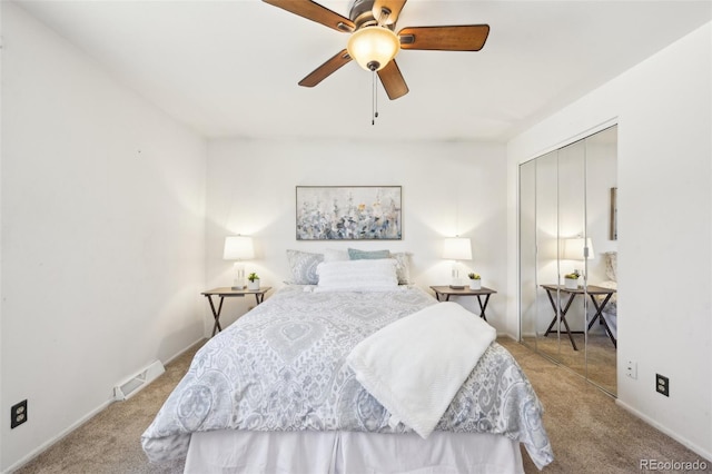 bedroom with visible vents, a closet, carpet flooring, baseboards, and ceiling fan