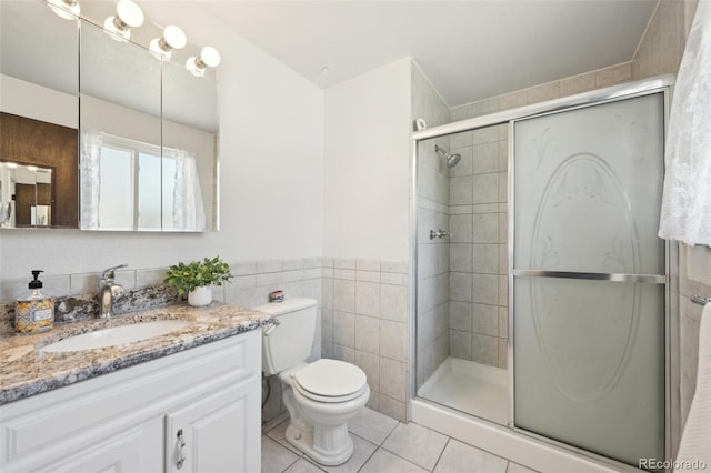 full bathroom featuring tile patterned floors, toilet, tile walls, and a stall shower