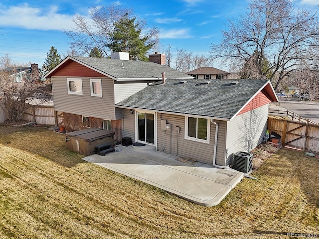 rear view of house featuring a patio area, central air condition unit, a lawn, and a fenced backyard