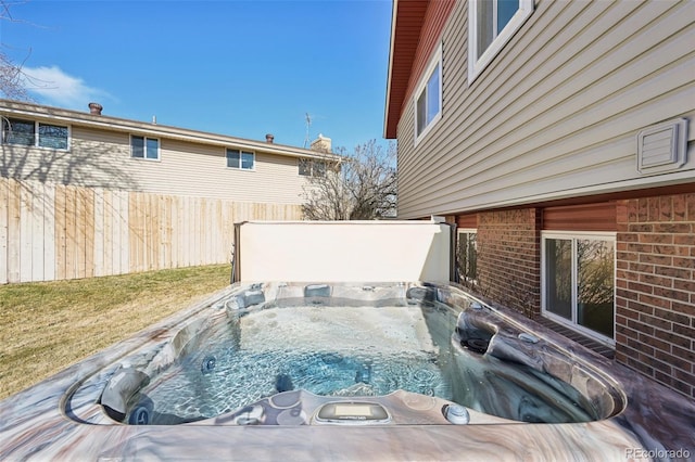 view of pool featuring a hot tub and fence