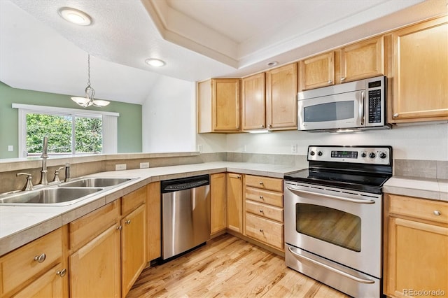 2330 S Salem Cir, Aurora, CO 80014 - kitchen featuring stainless steel appliances, light wood finished floors, light brown cabinets, a chandelier, and light countertops