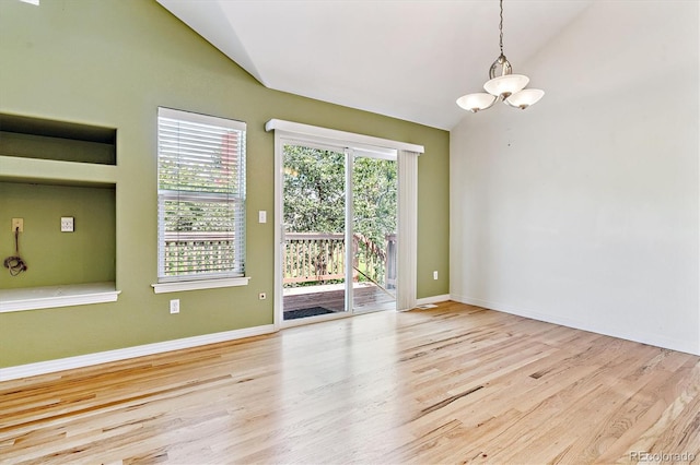 2330 S Salem Cir, Aurora, CO 80014 - unfurnished room featuring vaulted ceiling, a chandelier, and wood finished floors
