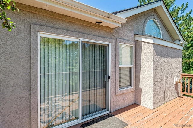 2330 S Salem Cir, Aurora, CO 80014 - view of exterior entry with stucco siding and a wooden deck