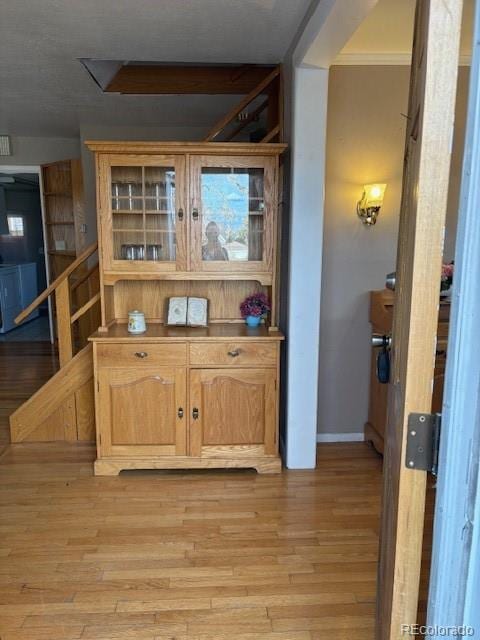 bar with light wood-style flooring and baseboards