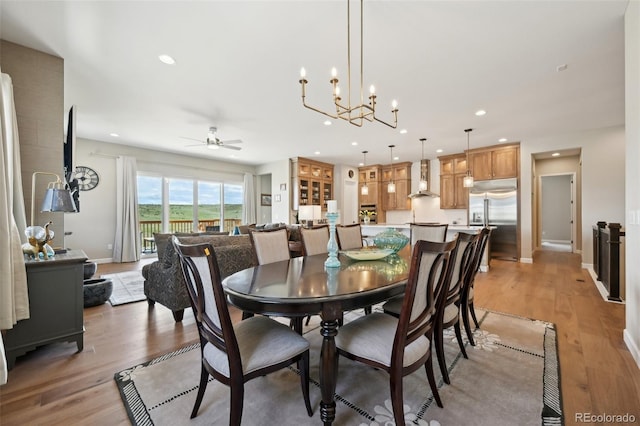 6980 S Yantley Ct, Aurora, CO 80016 - dining area featuring a ceiling fan, light wood-style floors, recessed lighting, a chandelier, and baseboards