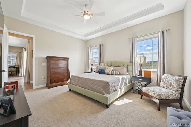 6980 S Yantley Ct, Aurora, CO 80016 - carpeted bedroom featuring a raised ceiling, multiple windows, a ceiling fan, and baseboards