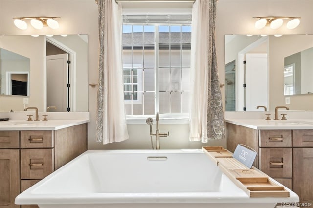 6980 S Yantley Ct, Aurora, CO 80016 - bathroom featuring a soaking tub and two vanities