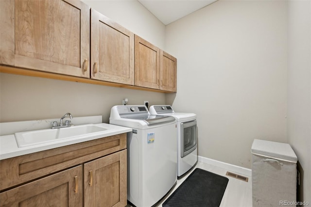 6980 S Yantley Ct, Aurora, CO 80016 - laundry area with washing machine and dryer, cabinet space, and baseboards