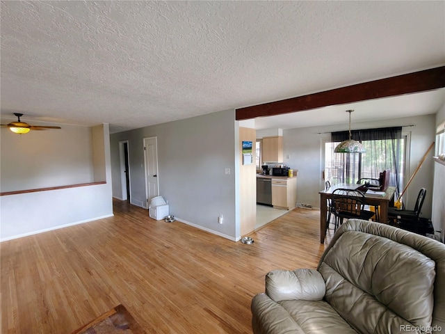 7409 Pierce St, Arvada, CO 80003 - living room featuring light wood-style floors, a textured ceiling, and ceiling fan