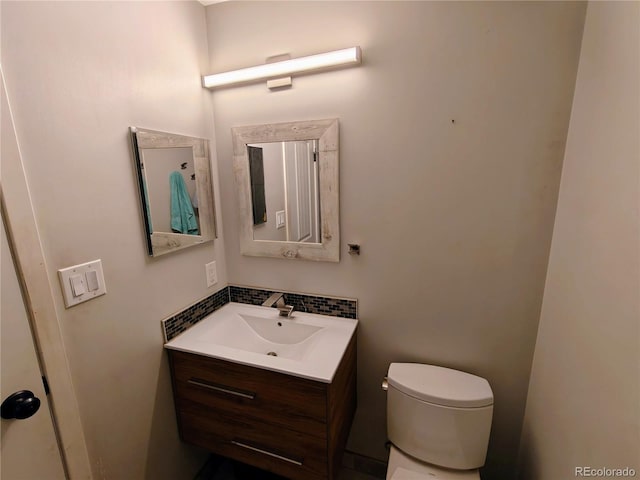 7409 Pierce St, Arvada, CO 80003 - half bath featuring vanity and tasteful backsplash