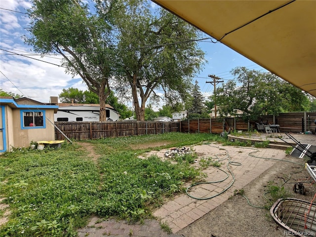 7409 Pierce St, Arvada, CO 80003 - fenced backyard featuring a patio area and an outbuilding