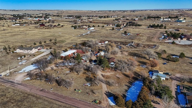 birds eye view of property with a rural view and a water view