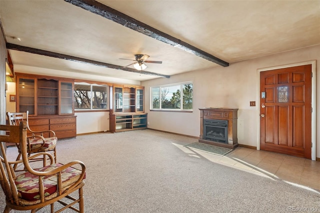 living room with beamed ceiling, ceiling fan, and light carpet