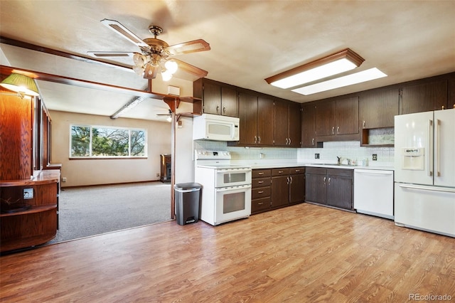 kitchen featuring decorative backsplash, light wood-type flooring, dark brown cabinets, white appliances, and ceiling fan