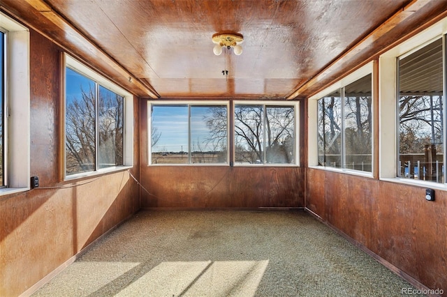 unfurnished sunroom featuring plenty of natural light and wooden ceiling