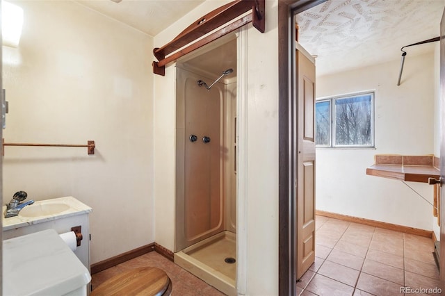 bathroom featuring toilet, tile patterned flooring, vanity, and walk in shower