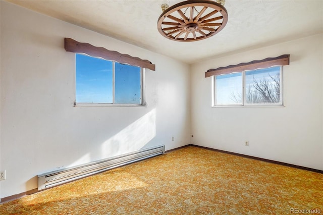 carpeted empty room with a baseboard radiator